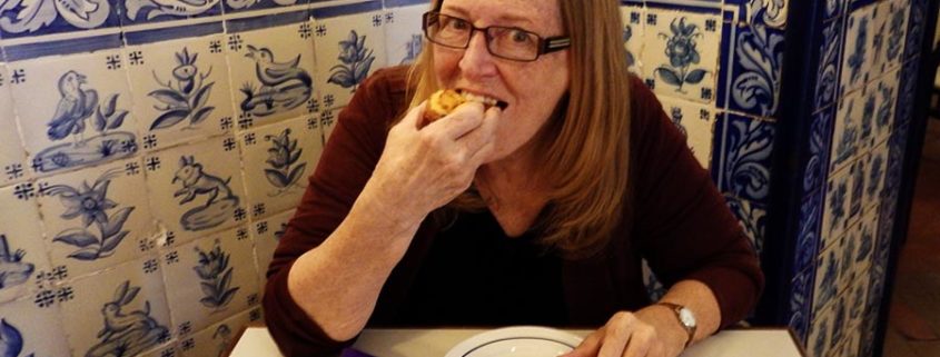 I bite into my first ever Pastéis de Belém in Lisbon, Portugal.